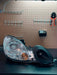 LunaticsCo MK1 Motorsport air ram with LED projector installed in a Lexus GS headlight assembly on a workbench.