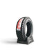 Lunaticsco Zeknova Gravel 09R rally competition tire with asymmetric tread pattern on a black display stand.