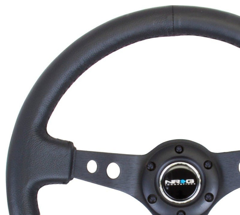 NRG Reinforced Steering Wheel (350mm / 3in. Deep) Blk Leather w/Blk Spoke & Circle Cutouts - Lunaticsco